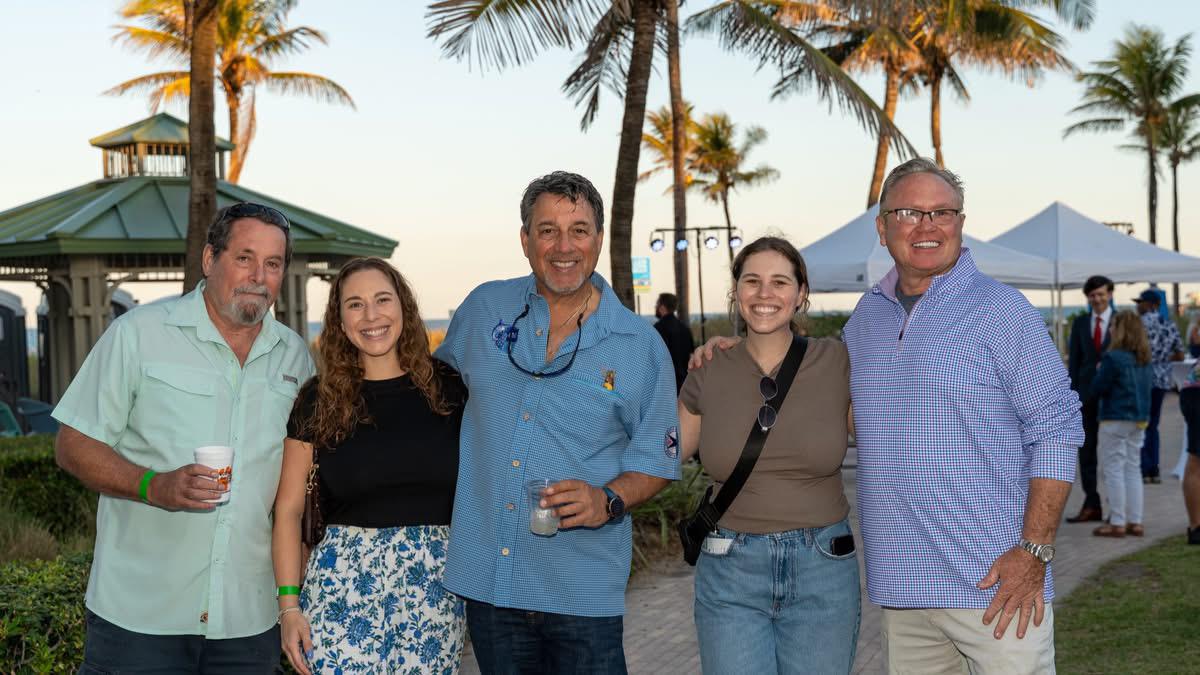 Randy Strauss with family and supporters at a beachfront community event