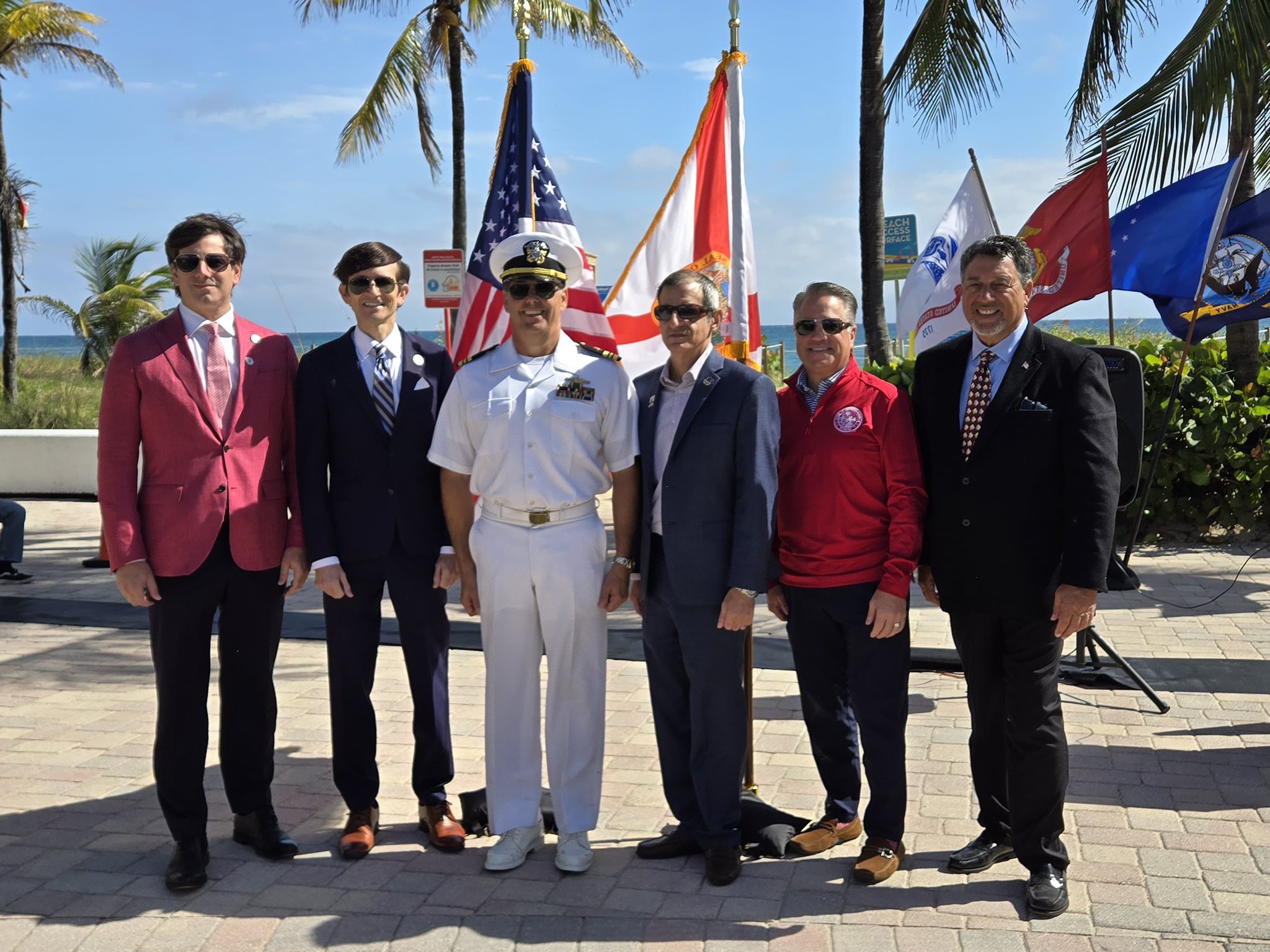 Randy Strauss with civic leaders and a Navy officer at a beachside ceremony in Lauderdale-by-the-Sea.