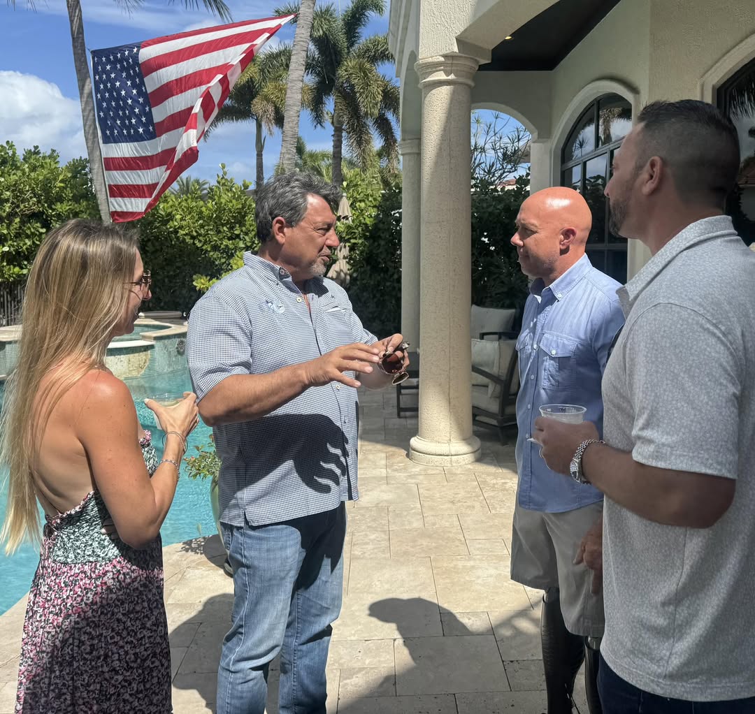 Randy Strauss talking with neighbors at a community gathering.
